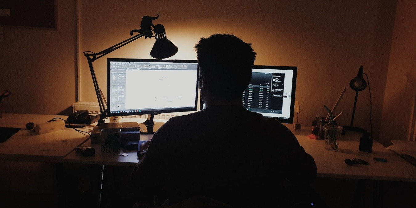 Man using Windows computer in a dimly-lit room