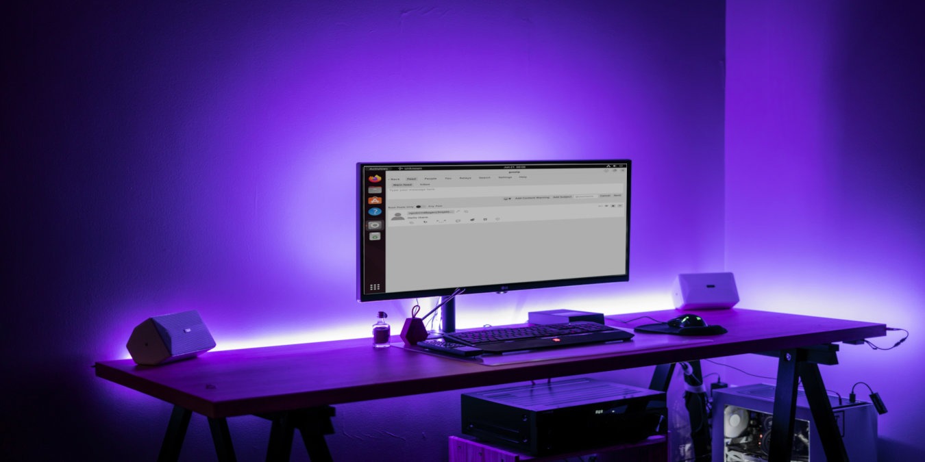 A photograph of a desktop computer in a dark room.