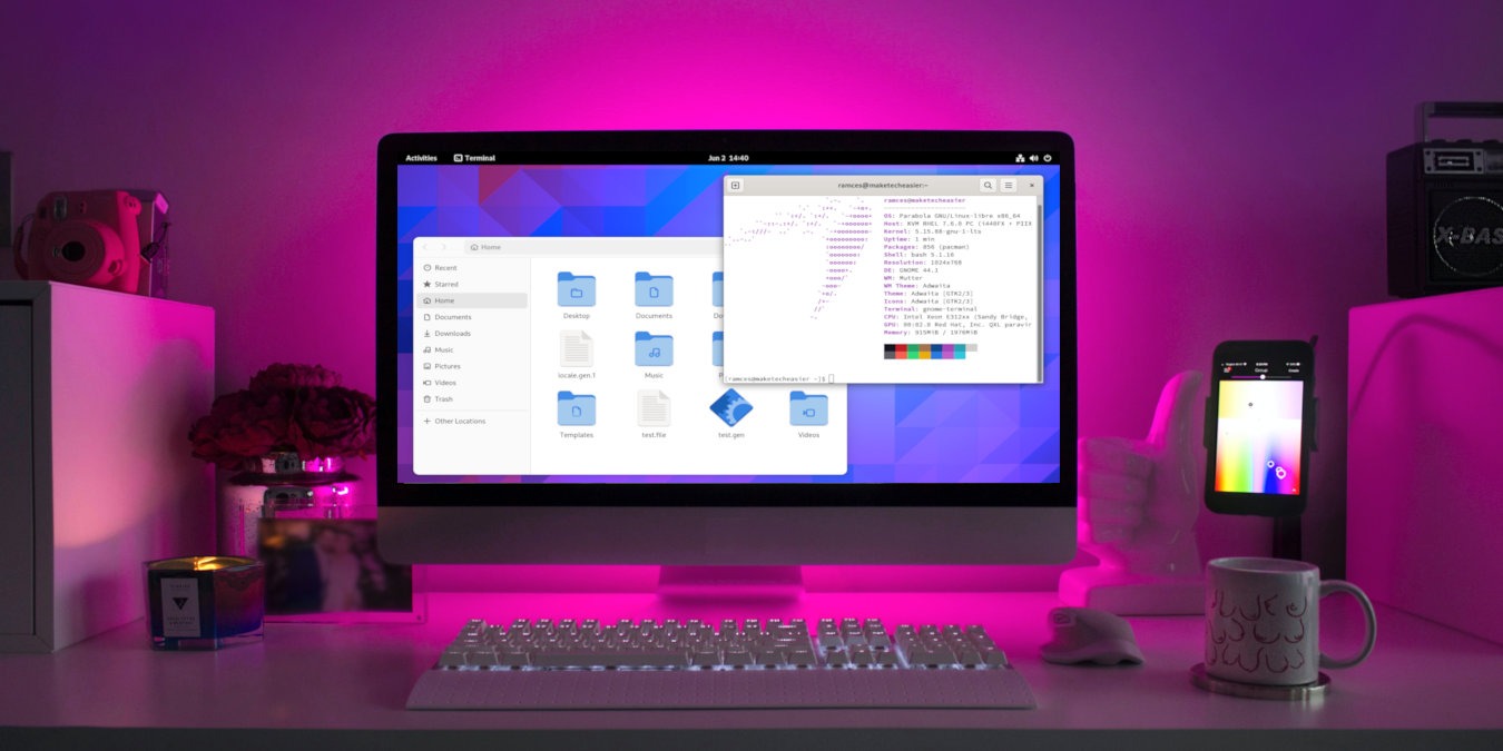 A photograph of a desktop computer with a purple light background.