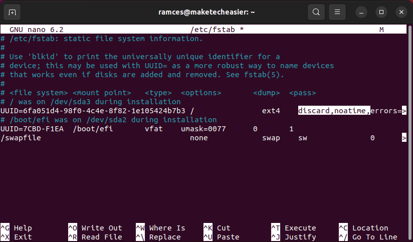 A terminal window showing the modified /etc/fstab file.
